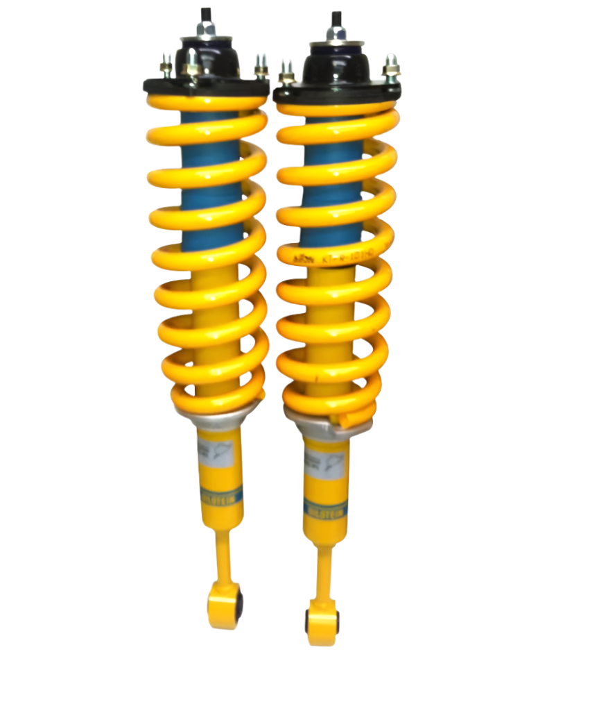 Two yellow shock absorbers on a white background