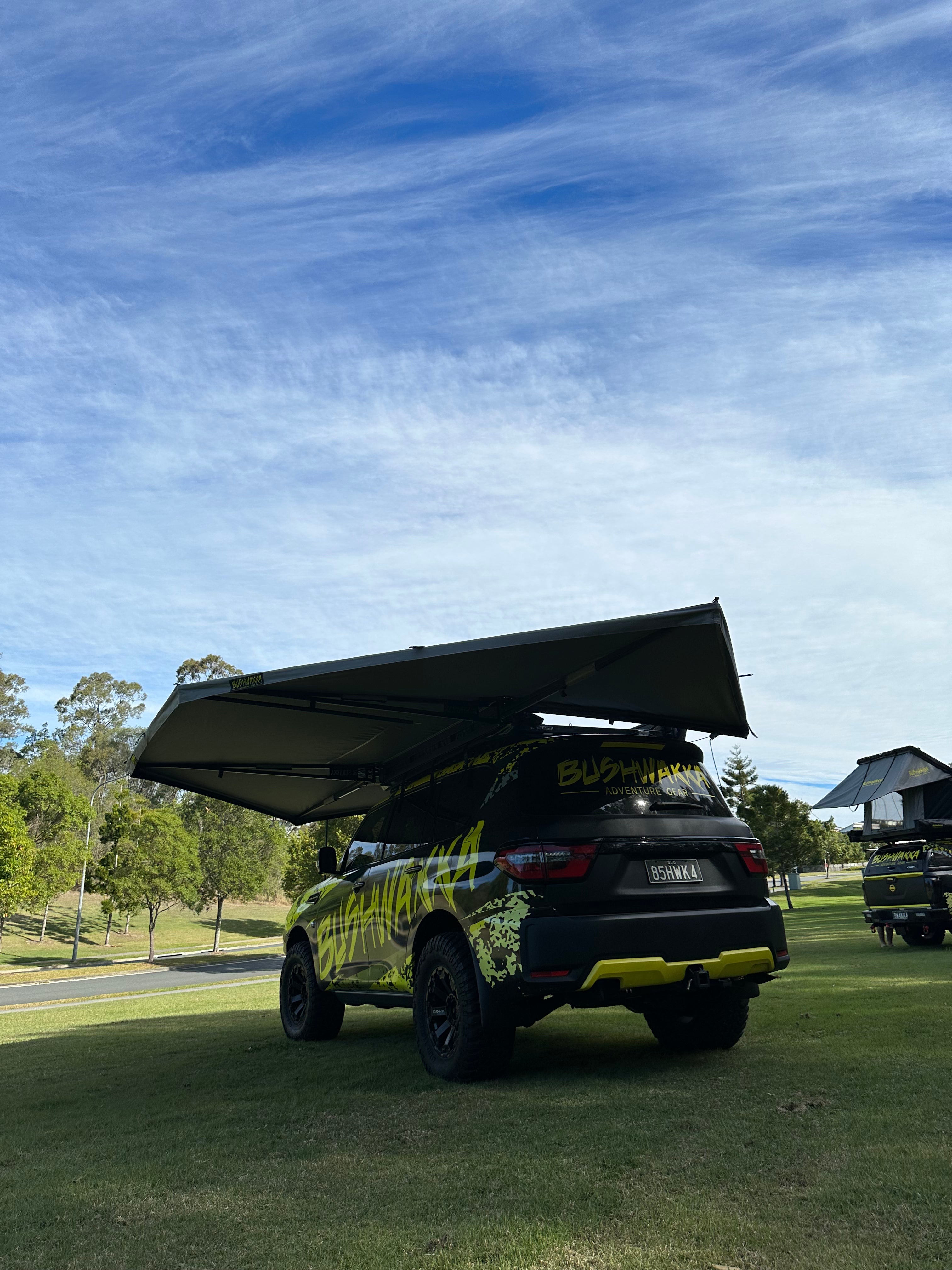 rooftop tent on a black car with bushwakka branding