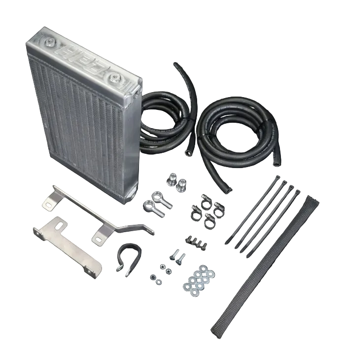 Car radiator kit with hoses, brackets, and fasteners on a black background