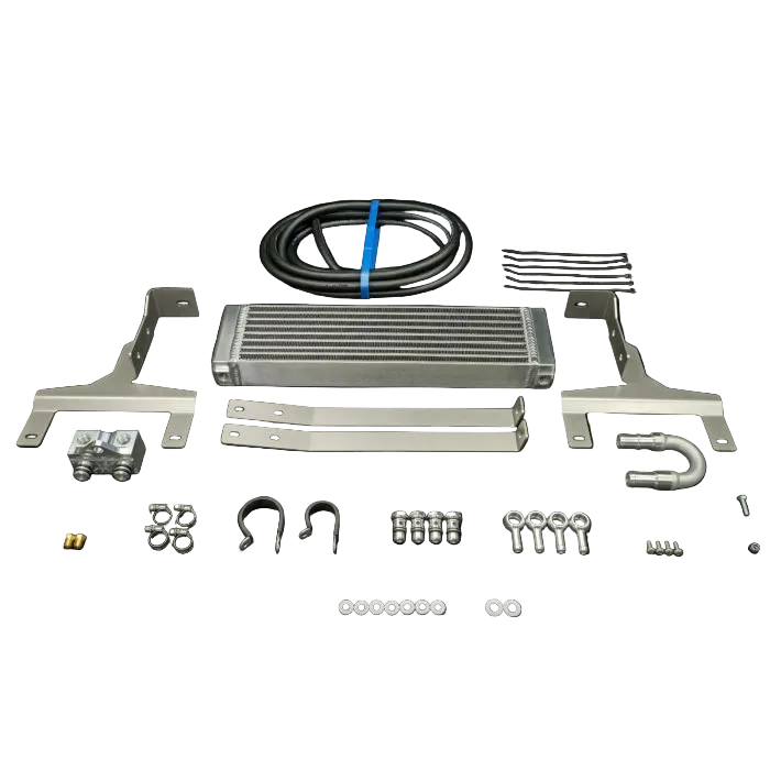 Collection of automotive parts including a metal intercooler, brackets, and hoses on a black background.